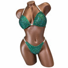 Front view of olive mystic competition bikini with emerald AB and black rhinestones on a mannequin