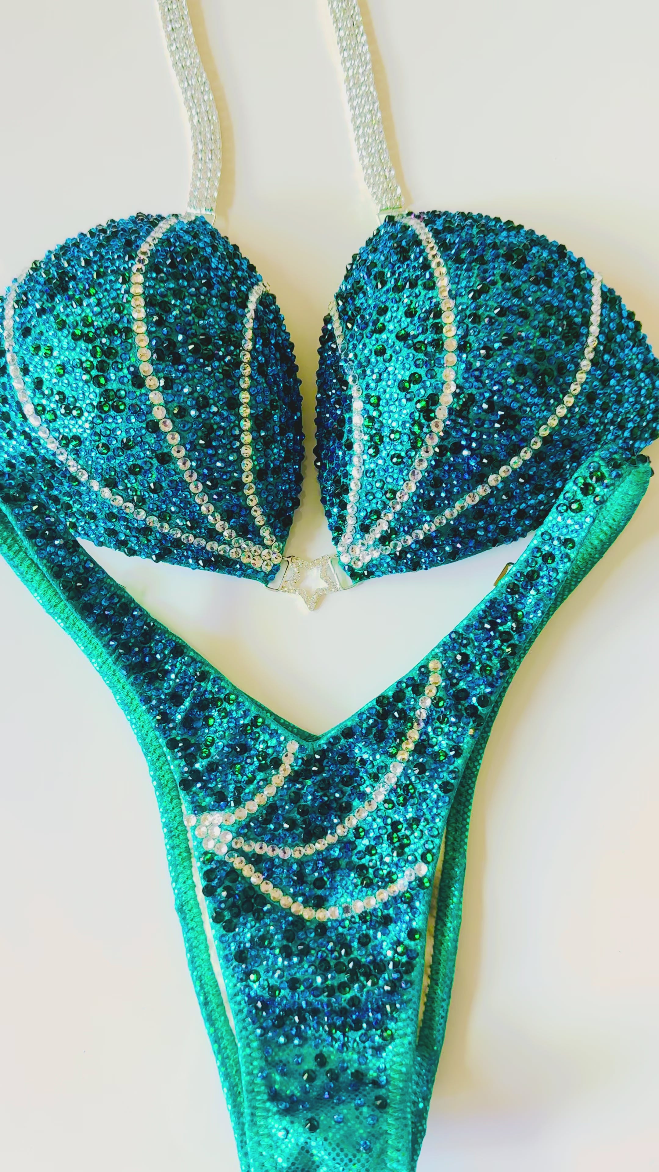 Emerald Wave Figure Competition Suit — Saleyla. Custom bikini suit made with emerald green rhinestones for stage-winning appearances.