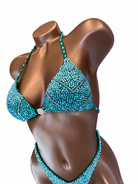 Teal Chevron competition suit top detail on a mannequin against a white background